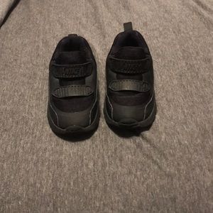Kids all black Nike sneakers
